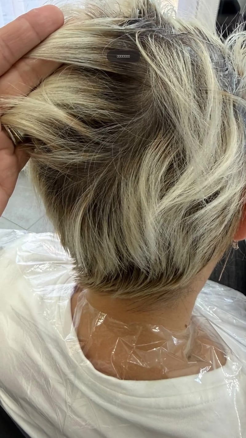 Păr scurt văzut din spate: înainte, cu rădăcini închise și lungimi blonde, și după tuns, decolorarea rădăcinilor și vopsit blond deschis.